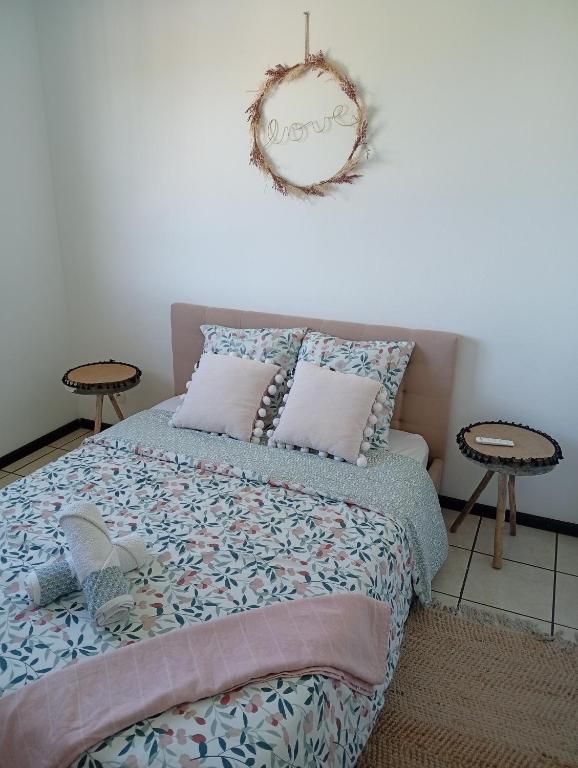 a bedroom with a bed with a wreath on the wall at Lodge Larkansièl in Entre-Deux