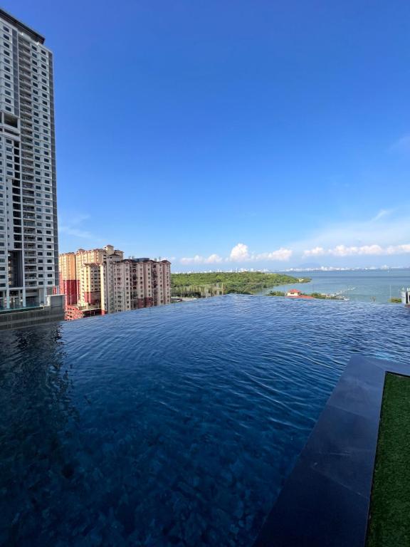 a view of the water from the balcony of a building at Georgetown Urban Family & Baby-Friendly Home with Skypool Seaview in Jelutong