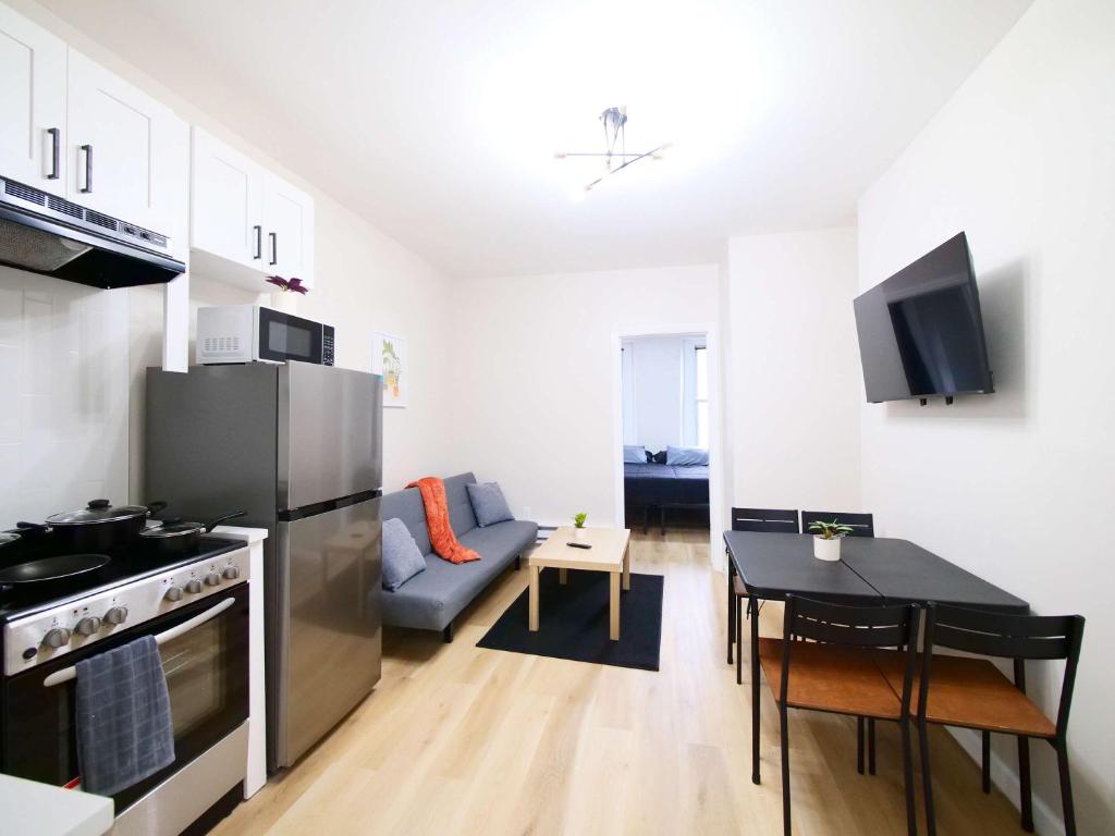 a kitchen and living room with a couch and a table at Comfy 1-Bedroom Escape Close to NYC with Wifi in Paterson