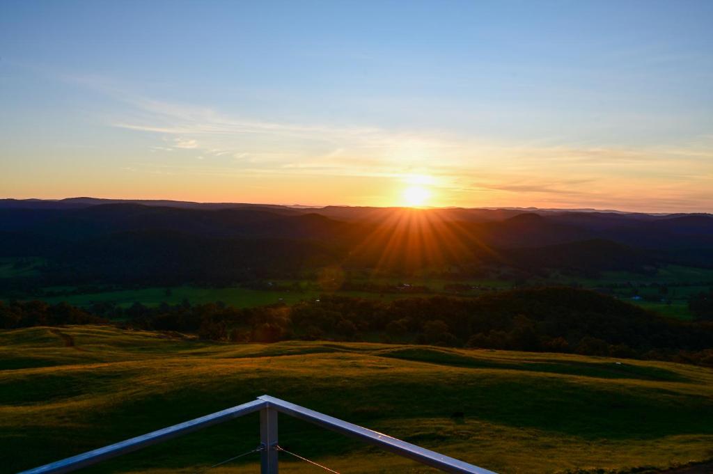 a sunset from the top of a hill with a fence at Elevation652 at Mt Bellevue in King Valley in Myrrhee