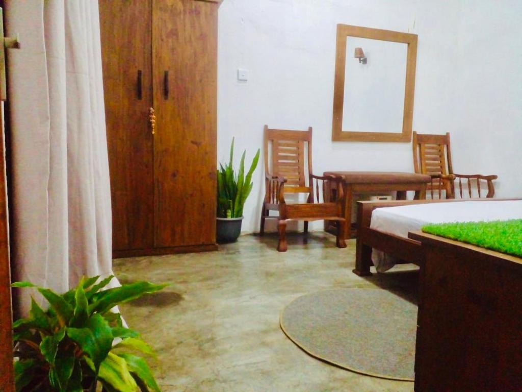 a bedroom with a bed and a table and chairs at S97 Weligama in Weligama
