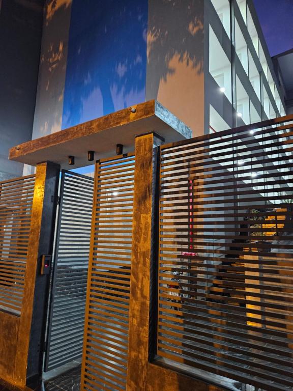 a building with a window with blinds on it at Easy Access Apartment - Ciudad del Este in Ciudad del Este