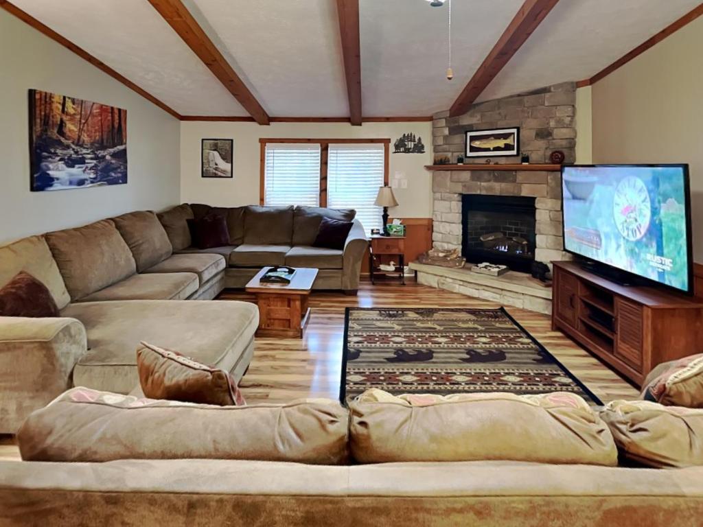 a living room with a couch and a fireplace at Knotty Pines in Oakland