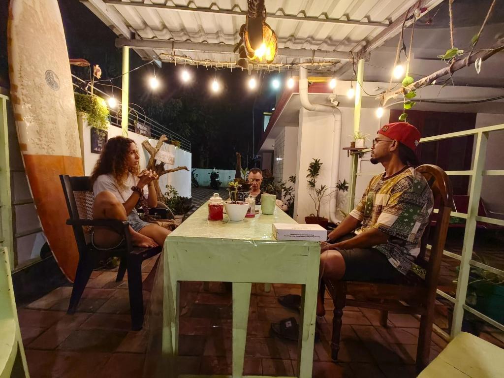 a group of people sitting at a table at Harmonic Hideout in Varkala