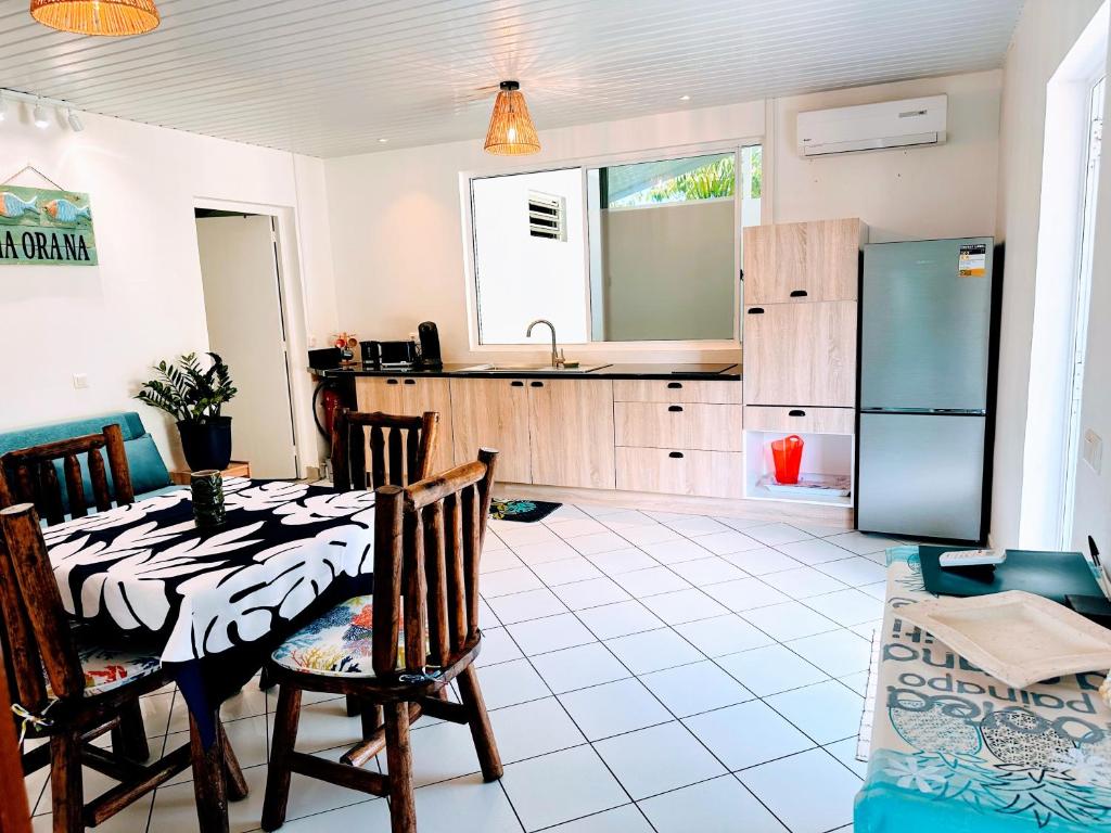 una cocina con una mesa y un refrigerador en Manahiti properties, en Moorea