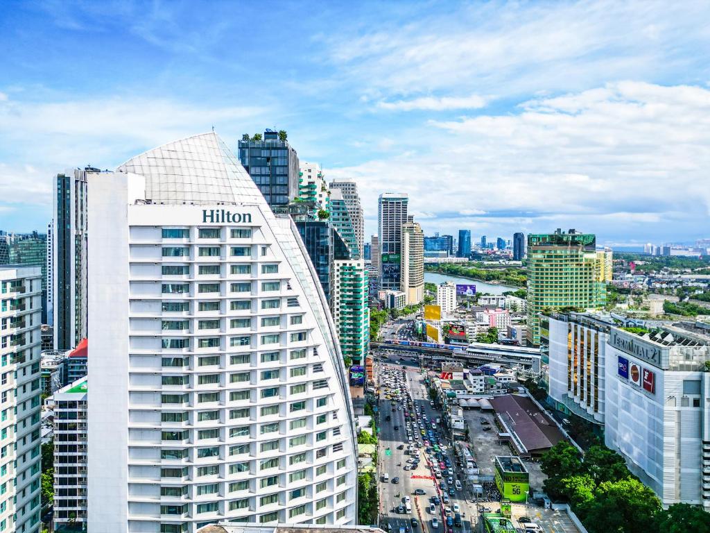 a view of a city with a lot of buildings at Hilton Bangkok Grande Asoke in Bangkok
