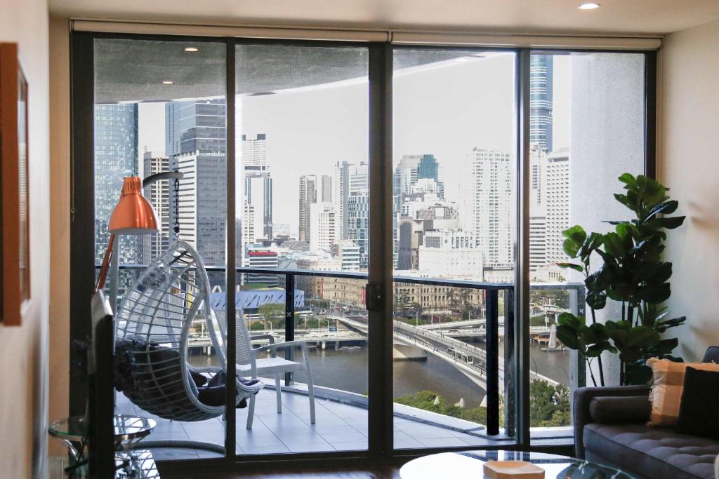 a room with a large window with a view of a city at Southbank exceptional View with huge balcony High Lvl Suite style APT in Brisbane