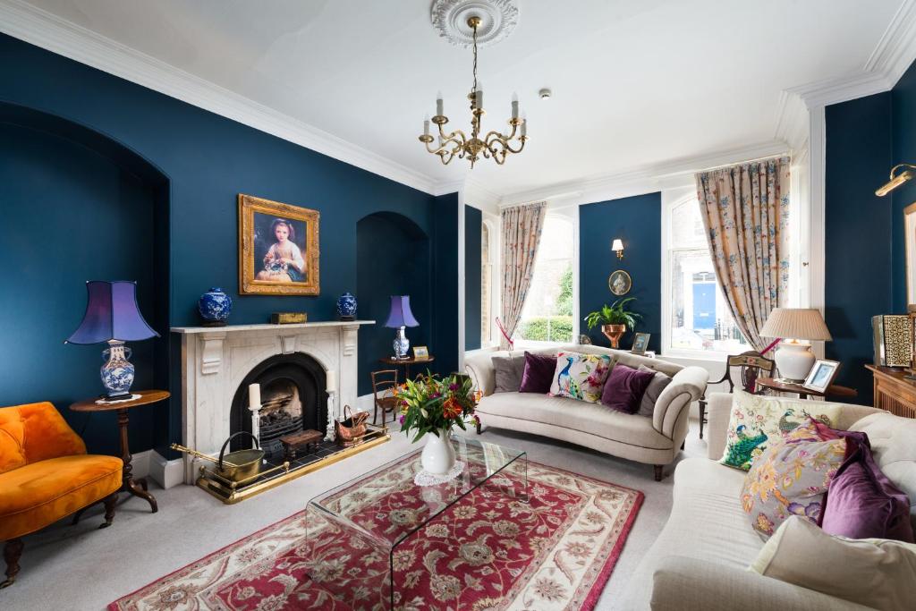 a living room with blue walls and a fireplace at 23 St Mary's in York