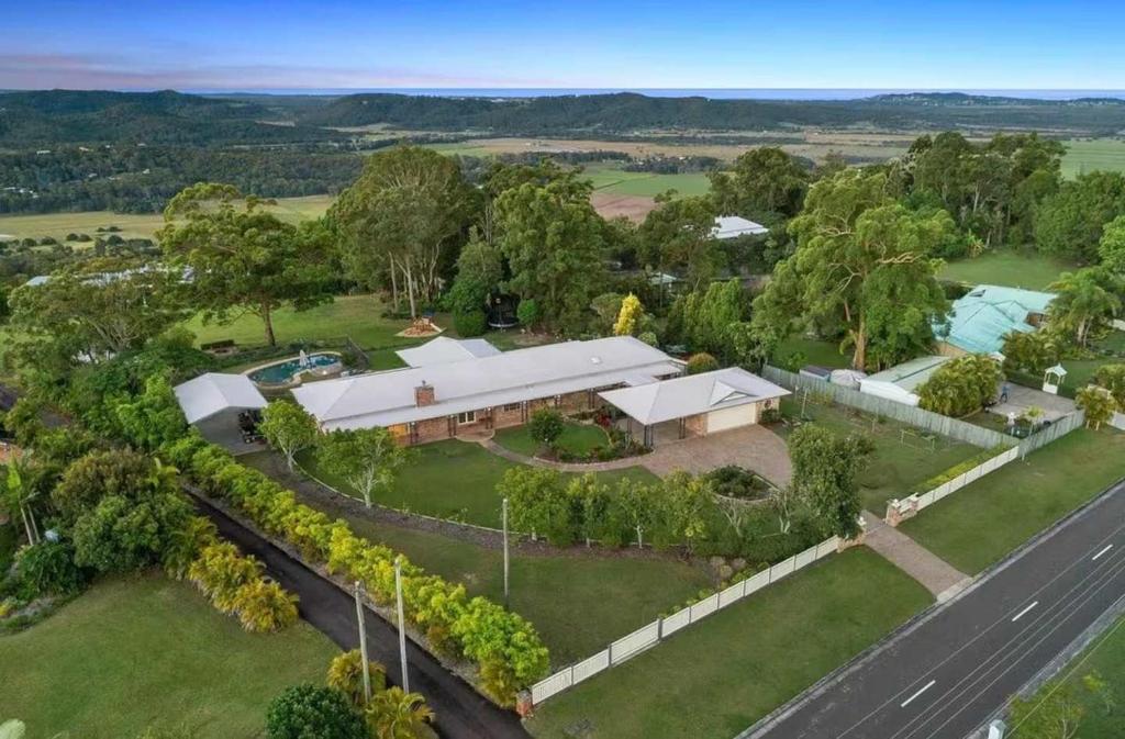 an aerial view of a house with a road at Coastview Manor - Family Hinterland Retreat in Valdora