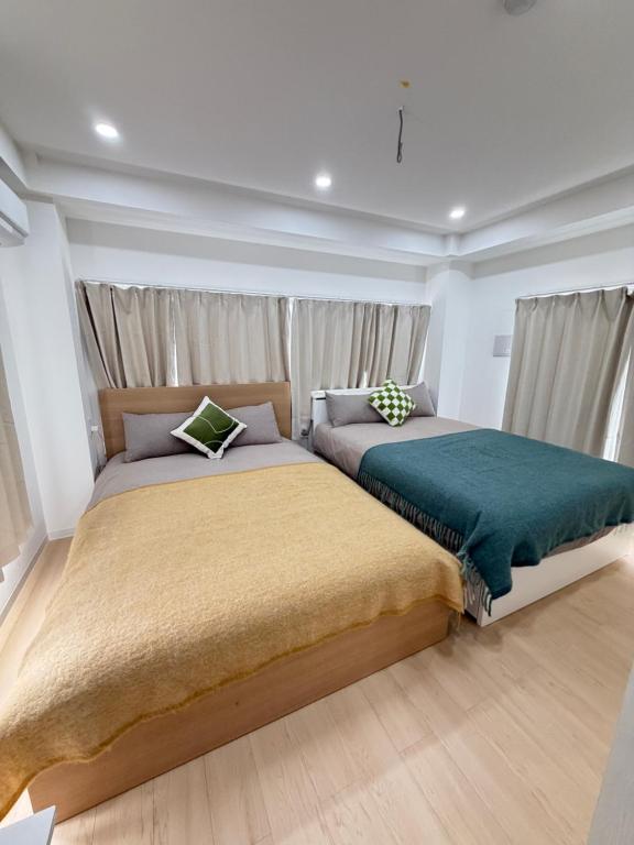 Ένα ή περισσότερα κρεβάτια σε δωμάτιο στο TOMI Hotel 神保町401