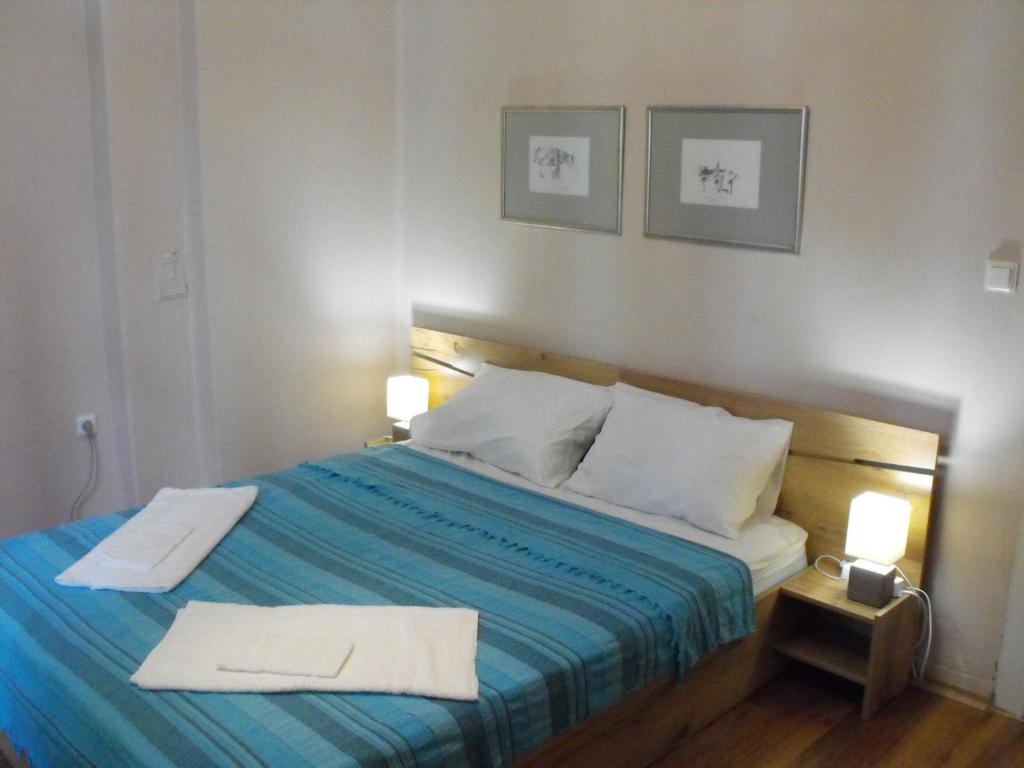 a bedroom with a bed with two towels on it at Julia Garden in Burgas City