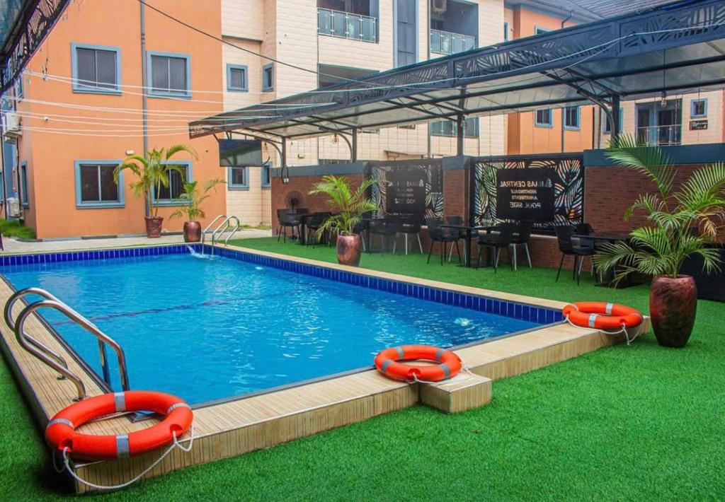 a swimming pool with orange inflatables in a building at Maas Nightingale Apartments in Port Harcourt