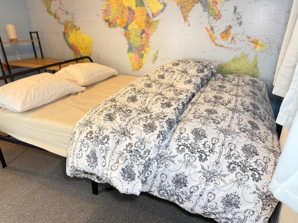 a bed in a room with a map on the wall at Bright Double Room in Wellingborough in Harrowden