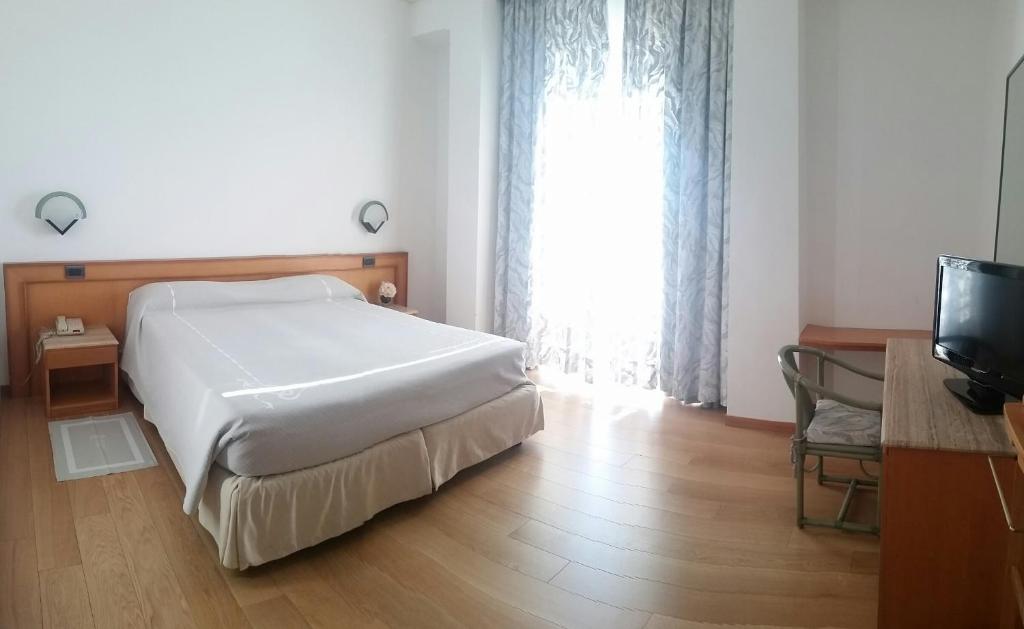 Postel nebo postele na pokoji v ubytování Hotel Excelsior