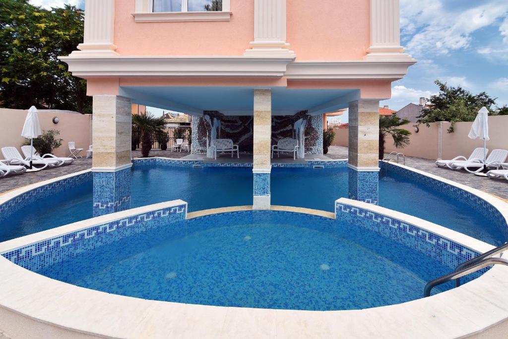 a swimming pool in the middle of a house at Sirena Palace Family Hotel in Obzor