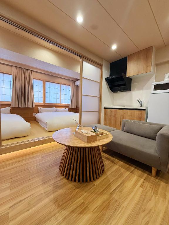 a living room with a couch and a table at Rakuyu asakusa in Tokyo