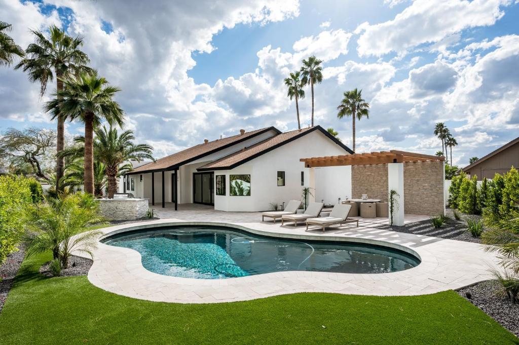 a swimming pool in the yard of a house at The MYAH by Porter NEWLY REMODELED Enjoy the Pool Firepit Luxury in Phoenix