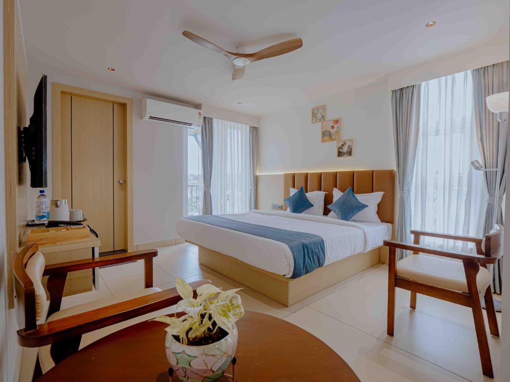 a hotel room with a bed and a table at Nine, Boutique hotel with luxury room stay, mysore in Mysore