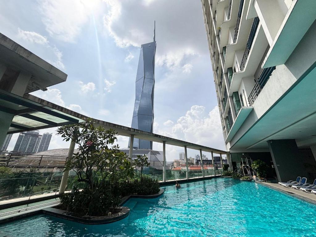 a view of the burj khalifa from a hotel swimming pool at Casa Residency Bukit Bintang by PILLOWTALKS in Kuala Lumpur