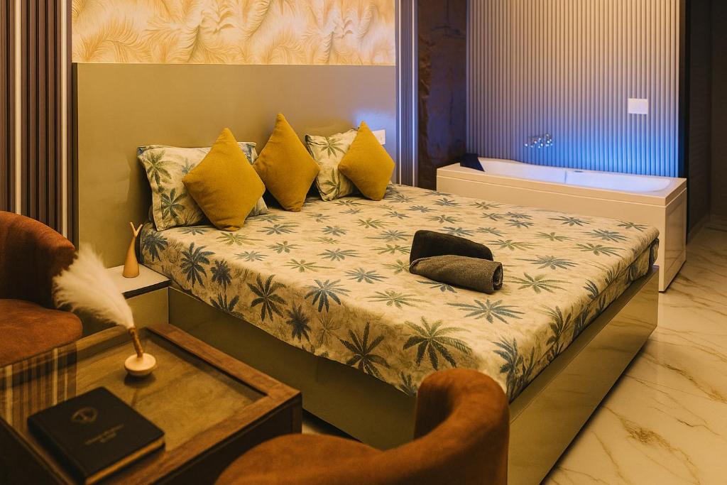a bedroom with a bed with yellow pillows at Suite with Private Jacuzzi in Ghaziabad