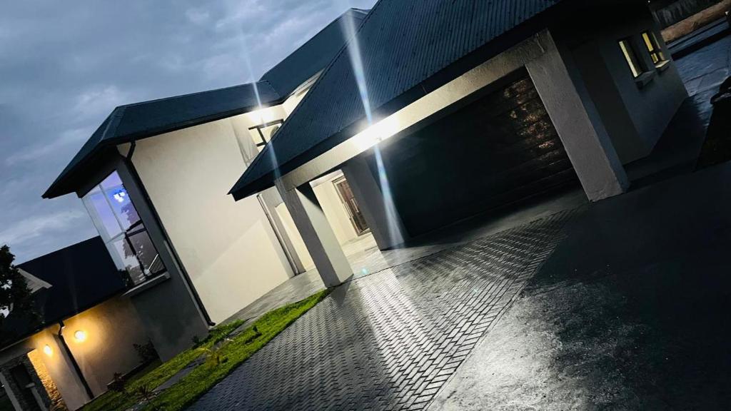 a house with the sun shining on the side of it at The Perazim Place in Hazyview