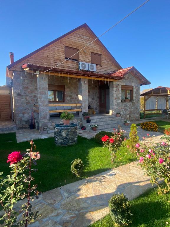 a house with a sign on the front of it at Villa Kadiu in Korçë