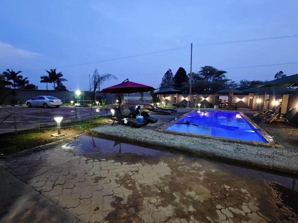 a swimming pool in a parking lot at night at sarahs apartments solwezi in Mpemba