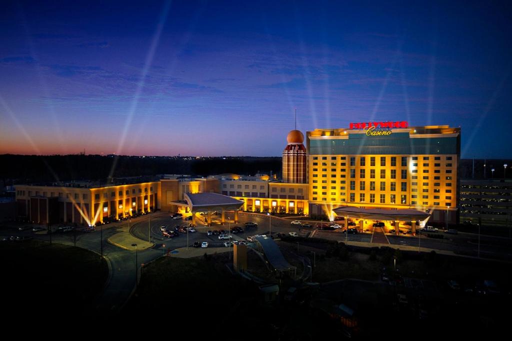 a hotel with a lit up building in a city at Hollywood Casino St. Louis in Maryland Heights