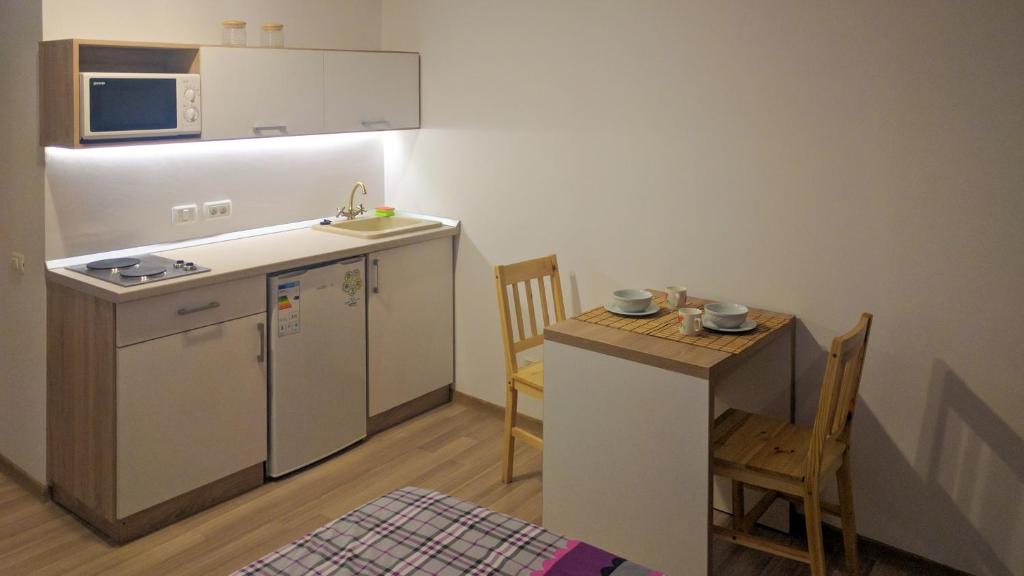 a small kitchen with a small table and a counter at BrasovApart Piata Sfatului in Braşov