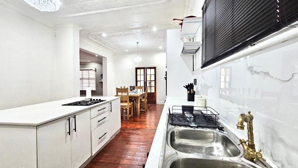 a kitchen with a sink and a counter top at Jacaranda Escape in Pretoria