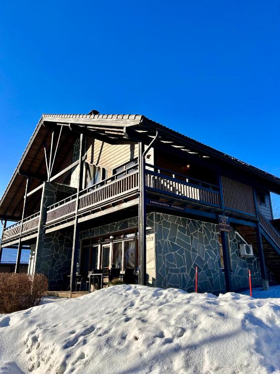 a large house in the snow with snow at Himos Mökki superior - Chalet Cottage superior ski-in-ski-out in Jämsä