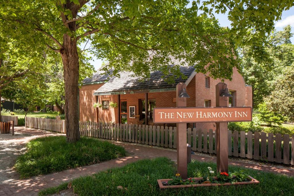 a sign in front of a building with a fence at New Harmony Inn Resort and Conference Center in New Harmony