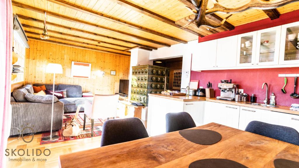 a kitchen and living room with a table and chairs at Chalet Dorle, Riederalp Golmenegg in Riederalp