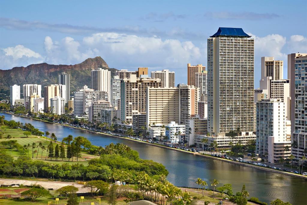 a view of a city with a river and buildings at Skyline Island Colony Hotel in Honolulu
