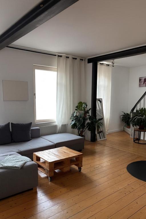 a living room with a couch and a coffee table at Cityapartment am historischen Wall in Aurich
