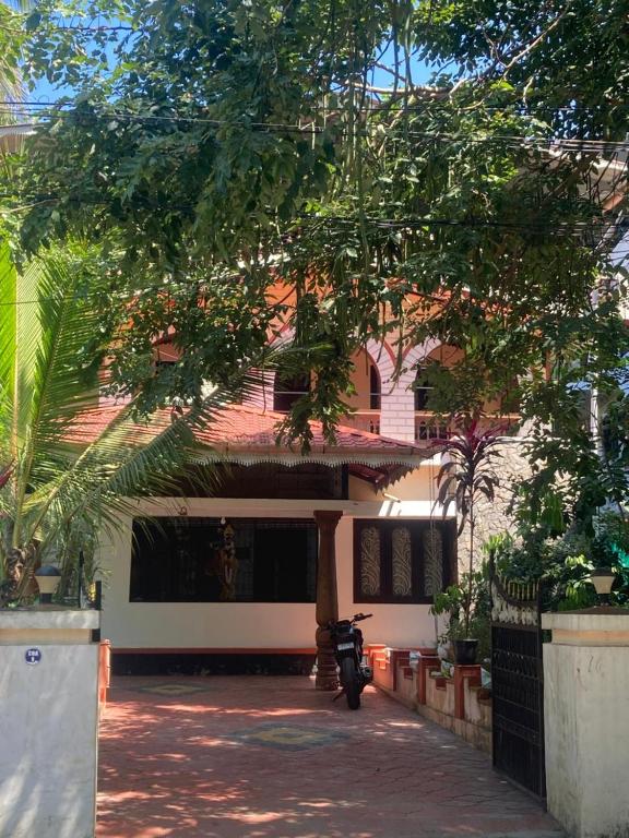 a motorcycle parked in front of a building at nandanam villlas in Guruvāyūr