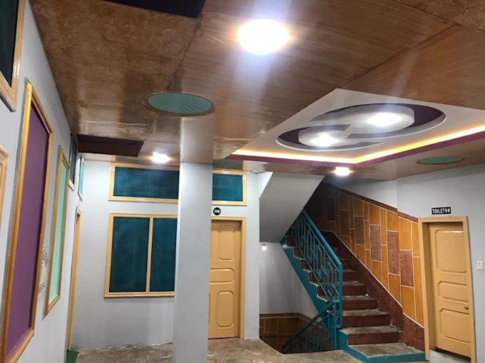a hallway with a spiral staircase in a building at Abu Dhabi Palace in Dargai