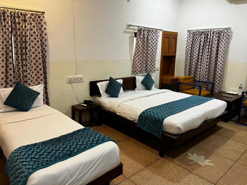 a hotel room with two beds in a room at Crown Plaza Heritage in Jodhpur