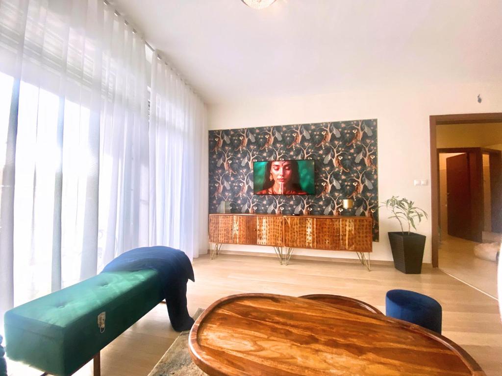 a living room with a couch and a table at Aupark Apartment Peacock in Piešťany