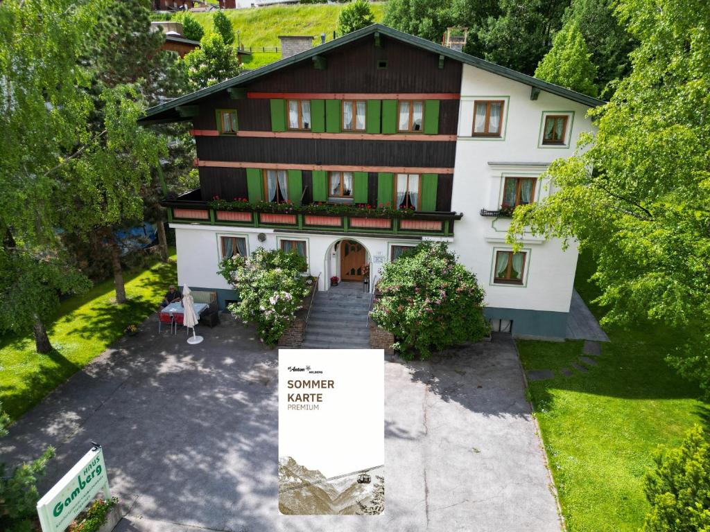 an aerial view of a house with a sign in front at Haus Gamberg & Premium Sommerkarte in Sankt Anton am Arlberg