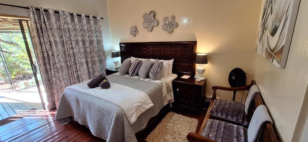 un dormitorio con una cama y una ventana en Mitat Guesthouse, en Beaufort West