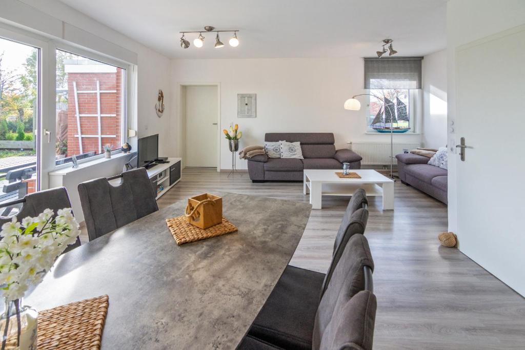 a living room with a couch and a table at Deichgraf in Dornumersiel