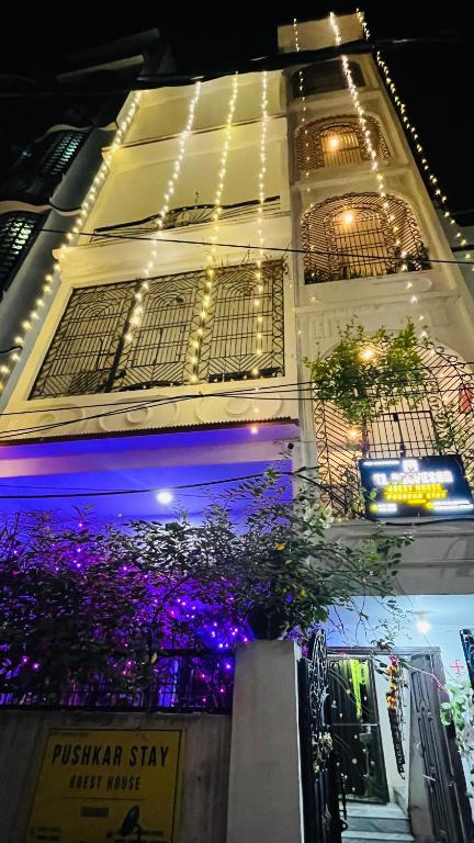 a building with lights on the side of it at Pushkar Stay in Varanasi