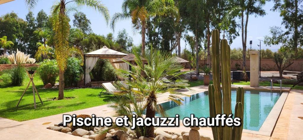a villa with a pool and a gazebo at Le Jardin de Jeanne in Marrakech