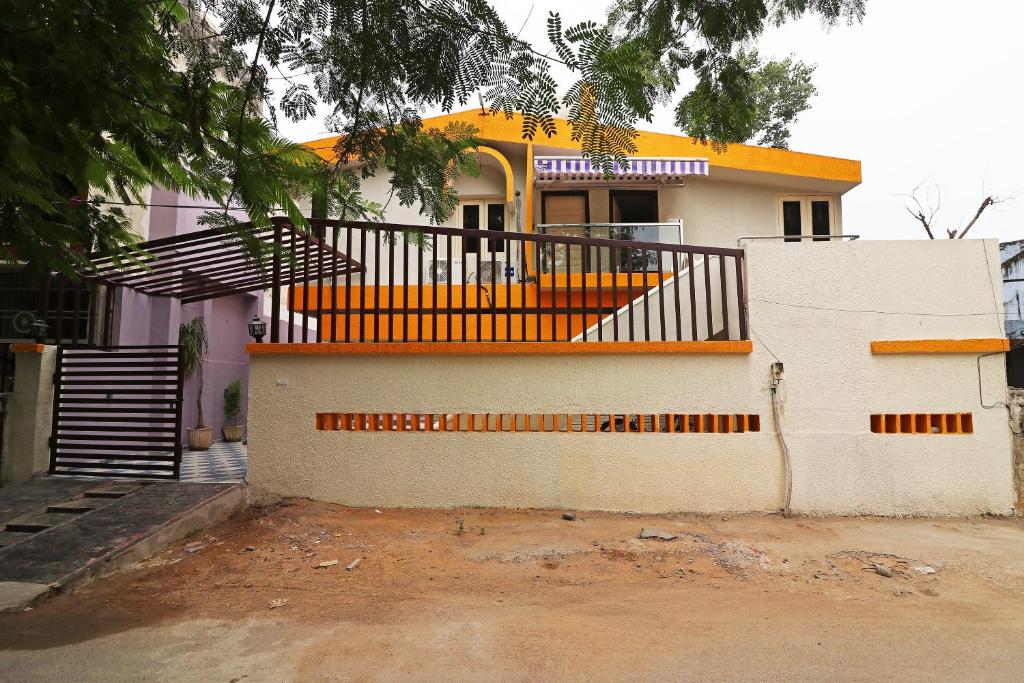 a house with an orange staircase in front of it at Hotel O Krishna Hotel and Restaurant in Raipur