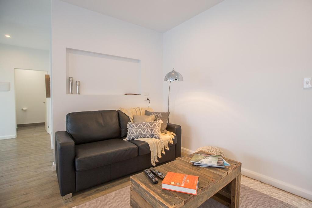 a living room with a leather couch and a coffee table at Island Quarters in Whitemark