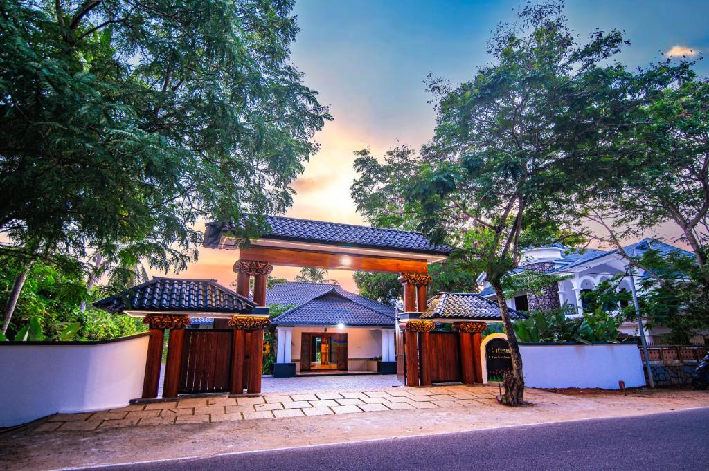 a house with a gate in front of it at Clifinn Wellness Beach Resort by nutmeg in Trivandrum