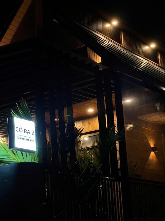 a sign on the side of a building at night at Villa Cô Ba 2 in Da Thanh