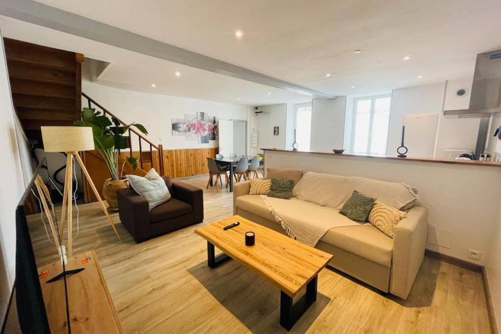 a living room with a couch and a table at La Maison de la Brousse in Brizambourg