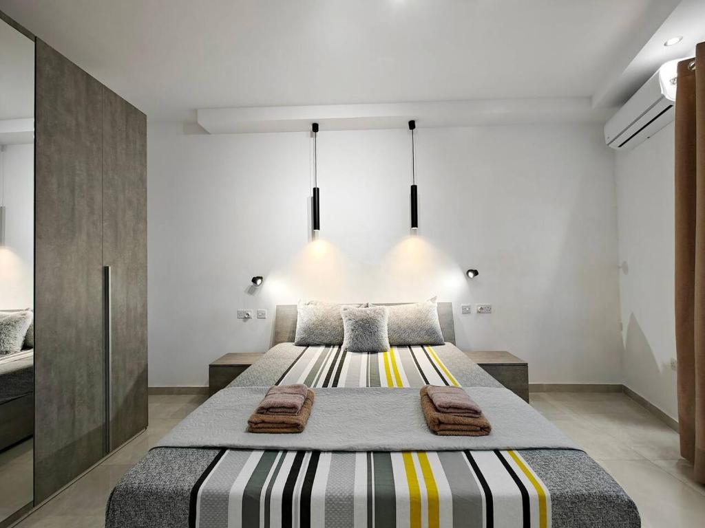 a bedroom with a large bed with towels on it at Valley View 1 in Luqa